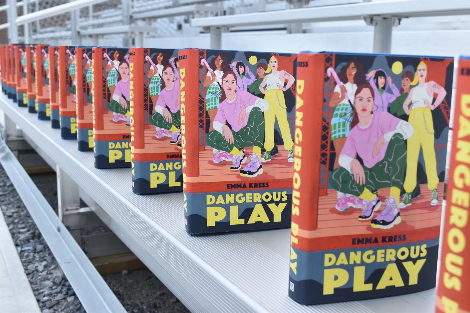 Copies of Dangerous Play lined up on stadium bleachers
